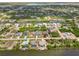 Scenic aerial view of a neighborhood featuring waterfront homes and interconnected canals at 15104 Aldama Cir, Port Charlotte, FL 33981