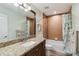 Neutral bathroom features a bathtub, modern vanity and shower with tan tile at 15104 Aldama Cir, Port Charlotte, FL 33981