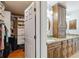 Bathroom with granite countertops, double sinks, wood cabinets and walk-in closet for storage at 15104 Aldama Cir, Port Charlotte, FL 33981