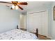 Bright bedroom features a ceiling fan, wood-look flooring, and a closet at 15104 Aldama Cir, Port Charlotte, FL 33981