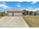 Charming single-story home with well-maintained landscaping and a three-car garage at 15104 Aldama Cir, Port Charlotte, FL 33981