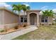 Inviting front entrance with stone accents and lush landscaping at 15104 Aldama Cir, Port Charlotte, FL 33981