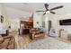 Open-concept living room and kitchen with modern ceiling fan and tile floors creates a spacious living area at 15104 Aldama Cir, Port Charlotte, FL 33981