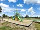 Community playground with slides, climbing structure, and basketball court for outdoor fun at 15104 Aldama Cir, Port Charlotte, FL 33981