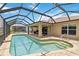 Relax in this inviting screened-in pool with a beautiful view of the lake at 15104 Aldama Cir, Port Charlotte, FL 33981
