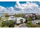 Aerial view of a community featuring commercial buildings, lake, and beautiful landscaping at 16965 Hawk Ct, Punta Gorda, FL 33982