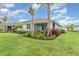 Scenic backyard showcasing vibrant landscaping, a well-kept lawn, and a screened patio, enhancing the outdoor living space at 16965 Hawk Ct, Punta Gorda, FL 33982