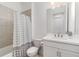 Bathroom featuring a shower with a shower curtain, toilet, and a vanity with a white countertop at 16965 Hawk Ct, Punta Gorda, FL 33982