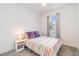 Bedroom featuring a bed with striped bedding and a window with light-filtering shades at 16965 Hawk Ct, Punta Gorda, FL 33982