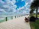 Scenic boardwalk overlooking the lake, surrounded by lush greenery and palm trees at 16965 Hawk Ct, Punta Gorda, FL 33982