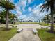 Community splash pad and seating area surrounded by palm trees and green spaces at 16965 Hawk Ct, Punta Gorda, FL 33982