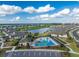 Scenic aerial shot of a community pool area, featuring a lakeside view, tropical landscaping, and recreational facilities at 16965 Hawk Ct, Punta Gorda, FL 33982