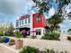 A discovery center featuring modern architectural details, outdoor seating, and lush landscaping at 16965 Hawk Ct, Punta Gorda, FL 33982