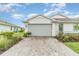 Charming single-Gathering home featuring a two-car garage, paver driveway, and beautifully landscaped front yard at 16965 Hawk Ct, Punta Gorda, FL 33982