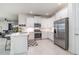 Modern kitchen with white cabinets, stainless steel appliances, and an island featuring a breakfast bar at 16965 Hawk Ct, Punta Gorda, FL 33982