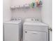 Laundry room featuring a white washer and dryer and shelving for storage at 16965 Hawk Ct, Punta Gorda, FL 33982
