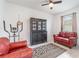 Living room with a black china cabinet, red leather chairs, and an exercise machine at 16965 Hawk Ct, Punta Gorda, FL 33982