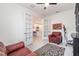 Living room featuring views of the kitchen through french doors, red leather chairs, and an exercise machine at 16965 Hawk Ct, Punta Gorda, FL 33982