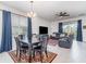 Open-concept living and dining area with a table, a comfortable sofa, and sliding doors to the outside at 16965 Hawk Ct, Punta Gorda, FL 33982