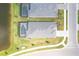 Aerial view of two homes with screened-in pools overlooking a tranquil pond and manicured lawns at 17557 Santorini Ct, Venice, FL 34293