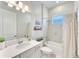 Well-lit bathroom featuring a combination tub and shower, sleek vanity, and modern fixtures for a relaxing experience at 17557 Santorini Ct, Venice, FL 34293