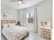 Comfortable bedroom featuring neutral tones, a window with natural light, and a dedicated vanity area for a cozy retreat at 17557 Santorini Ct, Venice, FL 34293