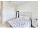 Cozy bedroom with a stylish bed, mirror, and bedside table, creating a peaceful and relaxing atmosphere at 17557 Santorini Ct, Venice, FL 34293