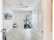 Bright bedroom with a ceiling fan, large closet, and neutral tile floor; ideal for a home gym or extra flex space at 17557 Santorini Ct, Venice, FL 34293