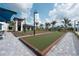 Community bocce ball courts surrounded by palm trees and clubhouse building, perfect for outdoor recreation at 17557 Santorini Ct, Venice, FL 34293