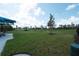 Well-maintained dog park with lush green grass, agility equipment, and seating areas in a fenced-in space at 17557 Santorini Ct, Venice, FL 34293