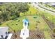 Aerial view of a dog park with various agility features, seating, and fenced perimeters in a community setting at 17557 Santorini Ct, Venice, FL 34293
