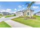 Beautiful single-Gathering home featuring manicured lawn, palm tree, and a paved driveway at 17557 Santorini Ct, Venice, FL 34293