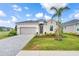 Charming single-Gathering home with a well-manicured lawn, lush landscaping, and a paved driveway at 17557 Santorini Ct, Venice, FL 34293