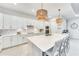 Gorgeous kitchen featuring oversized center island, quartz countertops, stainless steel appliances, and custom backsplash at 17557 Santorini Ct, Venice, FL 34293