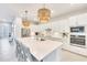 Gourmet kitchen boasts an oversized island, quartz countertops, stainless steel appliances, and ample cabinet space at 17557 Santorini Ct, Venice, FL 34293