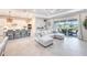 Open-concept design: Living room, kitchen, patio and neutral decor enhance the sense of spaciousness and airiness at 17557 Santorini Ct, Venice, FL 34293