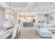 Bright and airy living room featuring neutral decor, dining area and seamless flow into the kitchen at 17557 Santorini Ct, Venice, FL 34293