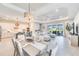 Spacious open-concept living area with dining and kitchen featuring seamless indoor-outdoor living with a large sliding door at 17557 Santorini Ct, Venice, FL 34293