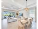 Well-lit open floorplan with dining and living area plus access to outdoor living space at 17557 Santorini Ct, Venice, FL 34293