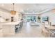 Open living space featuring a kitchen with bar seating, a dining area, and a living room with a sliding glass door at 17557 Santorini Ct, Venice, FL 34293