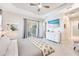 Spacious main bedroom offers a serene retreat with access to an outdoor patio, enhanced by a sleek, wall-mounted television at 17557 Santorini Ct, Venice, FL 34293