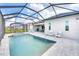 Screened-in pool area with a spa, poolside furniture, and a covered patio perfect for entertaining at 17557 Santorini Ct, Venice, FL 34293