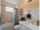 Well-lit bathroom with shower-tub combination and white vanity at 17857 Woodland Ct, Punta Gorda, FL 33982