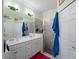 The bathroom is equipped with a glass shower and double sink at 17857 Woodland Ct, Punta Gorda, FL 33982