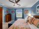 This primary bedroom features blue walls, decorative wall art, ceiling fan, and bench at 17857 Woodland Ct, Punta Gorda, FL 33982