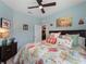 Comfortable bedroom featuring coastal decor, tropical bedding, and blue walls at 17857 Woodland Ct, Punta Gorda, FL 33982