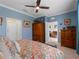 This bedroom has a ceiling fan, and view into an adjacent sitting area at 17857 Woodland Ct, Punta Gorda, FL 33982