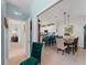 Open concept dining room with access to a hallway and a full view of the kitchen with bar seating at 17857 Woodland Ct, Punta Gorda, FL 33982