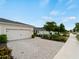 This property features a two-car garage and a paved driveway bordered by lush landscaping, for a well-maintained exterior at 17857 Woodland Ct, Punta Gorda, FL 33982