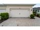 Garage doors featuring a white finish and stylish hardware, complemented by a paved driveway at 17857 Woodland Ct, Punta Gorda, FL 33982